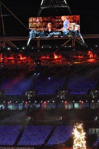Coldplay on screen 'Festival of the Flame' concert.