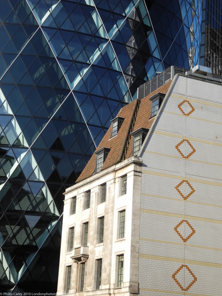 View of the Gherkin 30 St Mary's Axe - detail, and older building